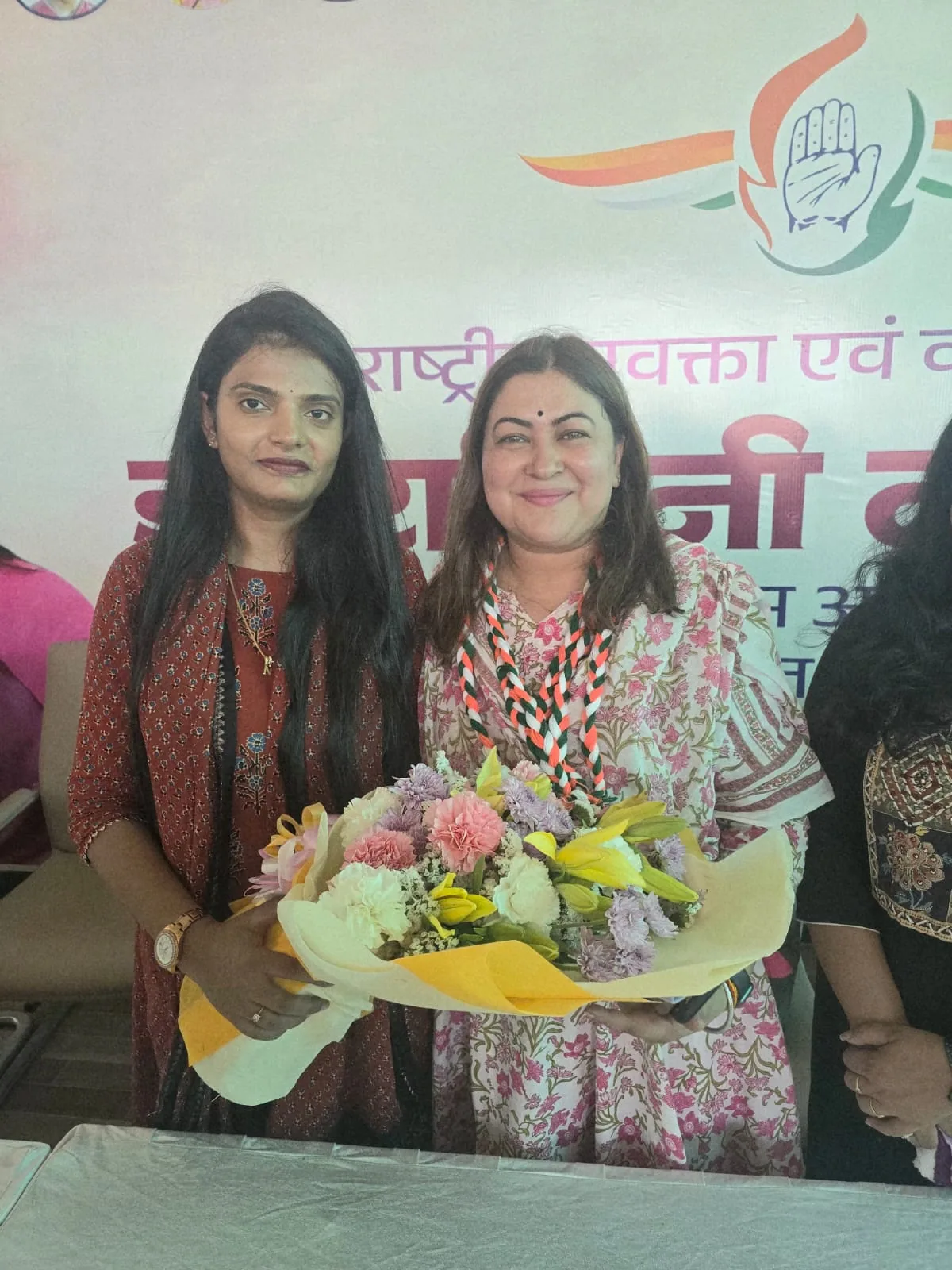 Dr. Nidhi Kant presenting flowers at a public gathering